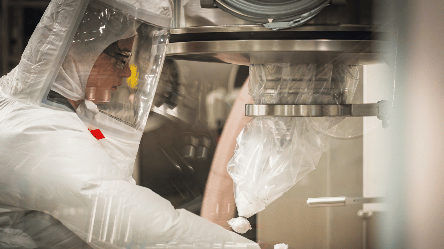 Young woman working in production and filling active ingredients 