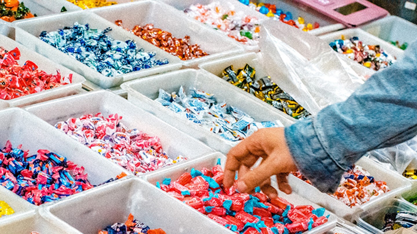 Many sweets with hand in denim jacket