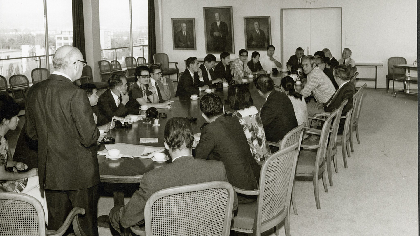 French delegation with corporate leadership in a conference room at the company headquarters in Ingelheim in 1973