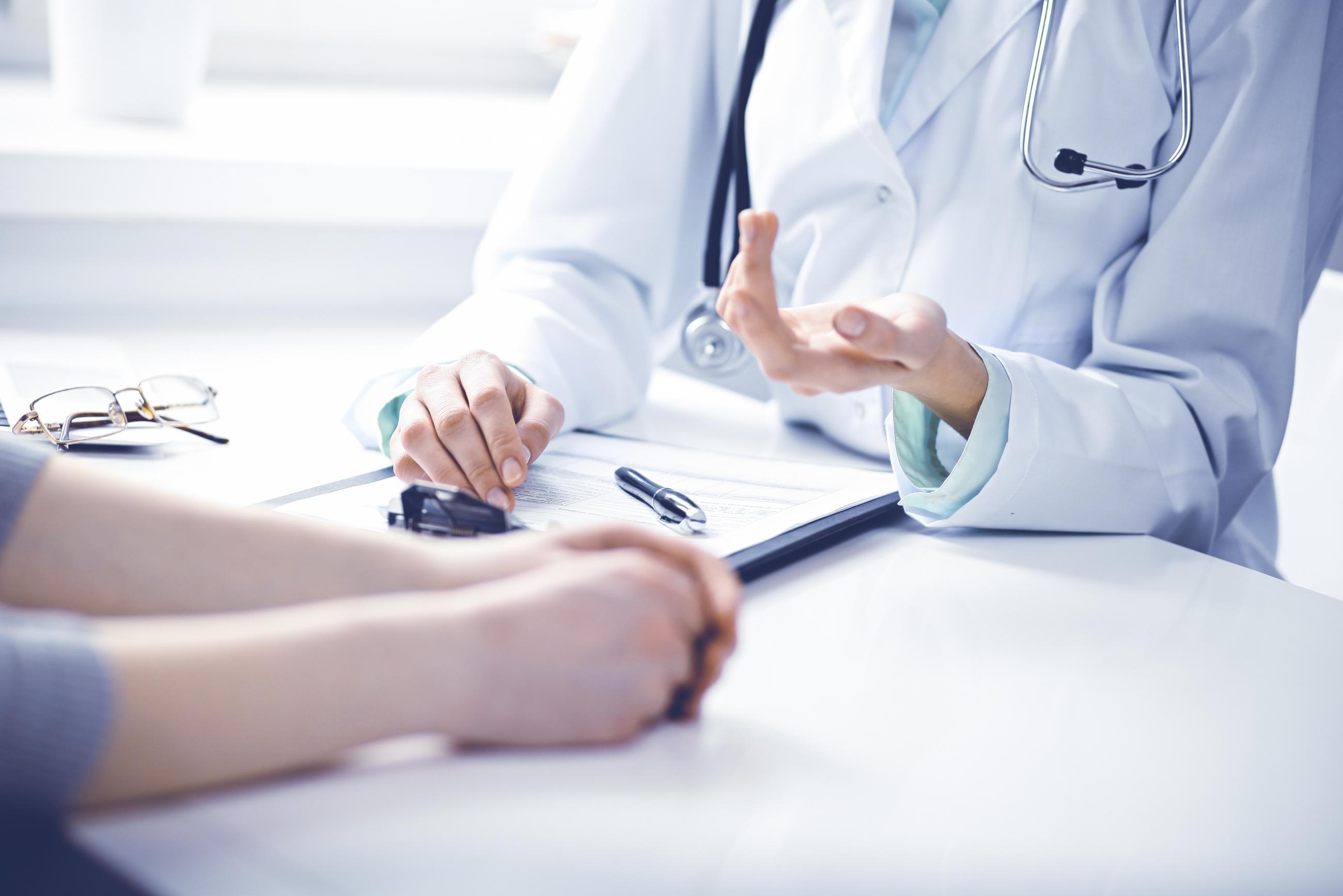 Patient and Doctor talking to each other. You can only see their hands