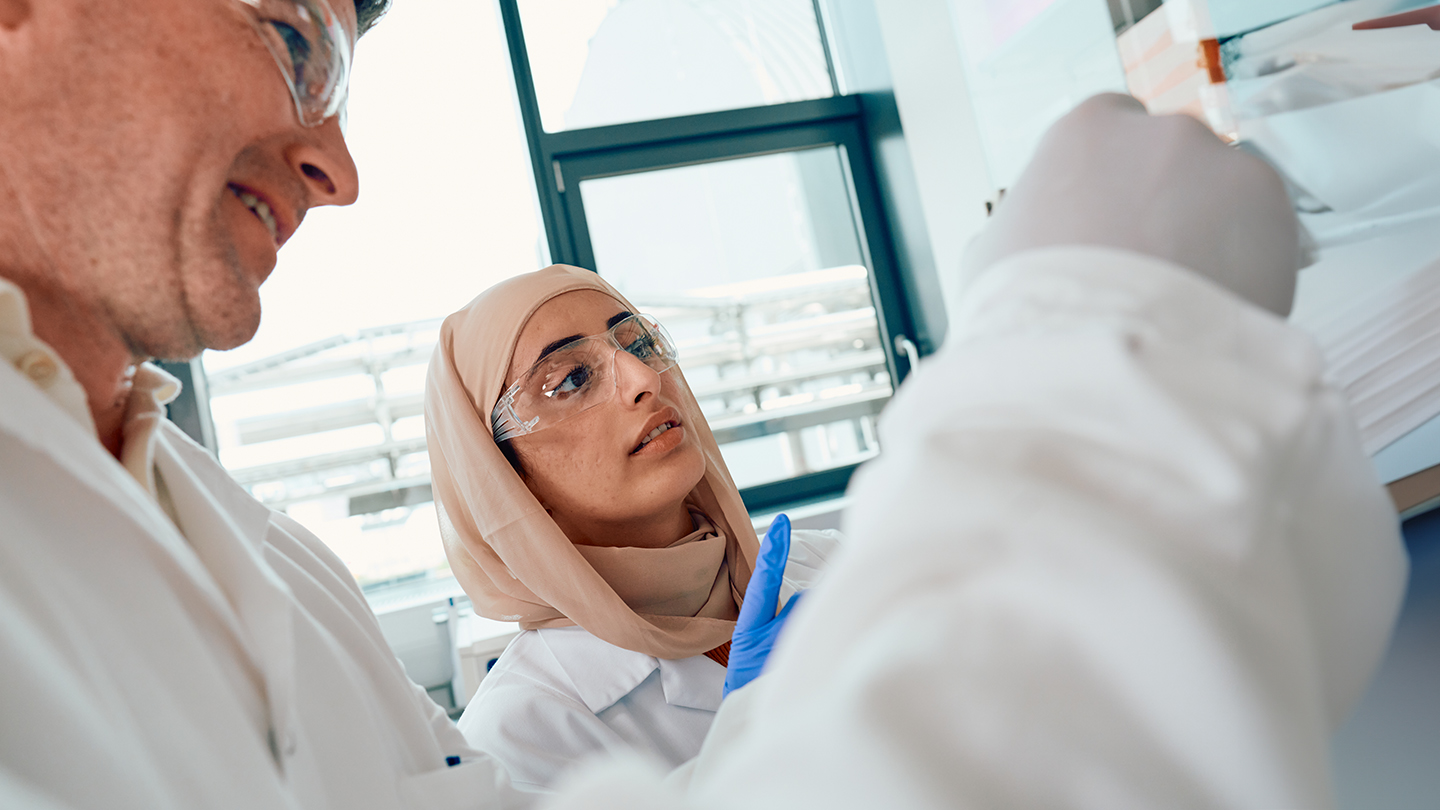 two scientists looking at petri dishes