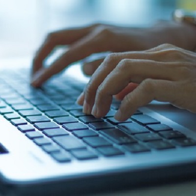 person typing on keyboard